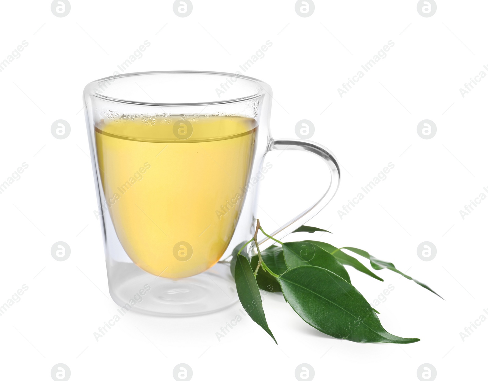 Photo of Fresh green tea in glass mug and leaves isolated on white