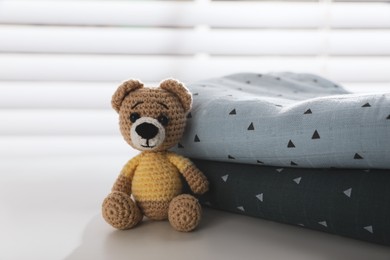 Photo of Baby clothes and toy bear on light table