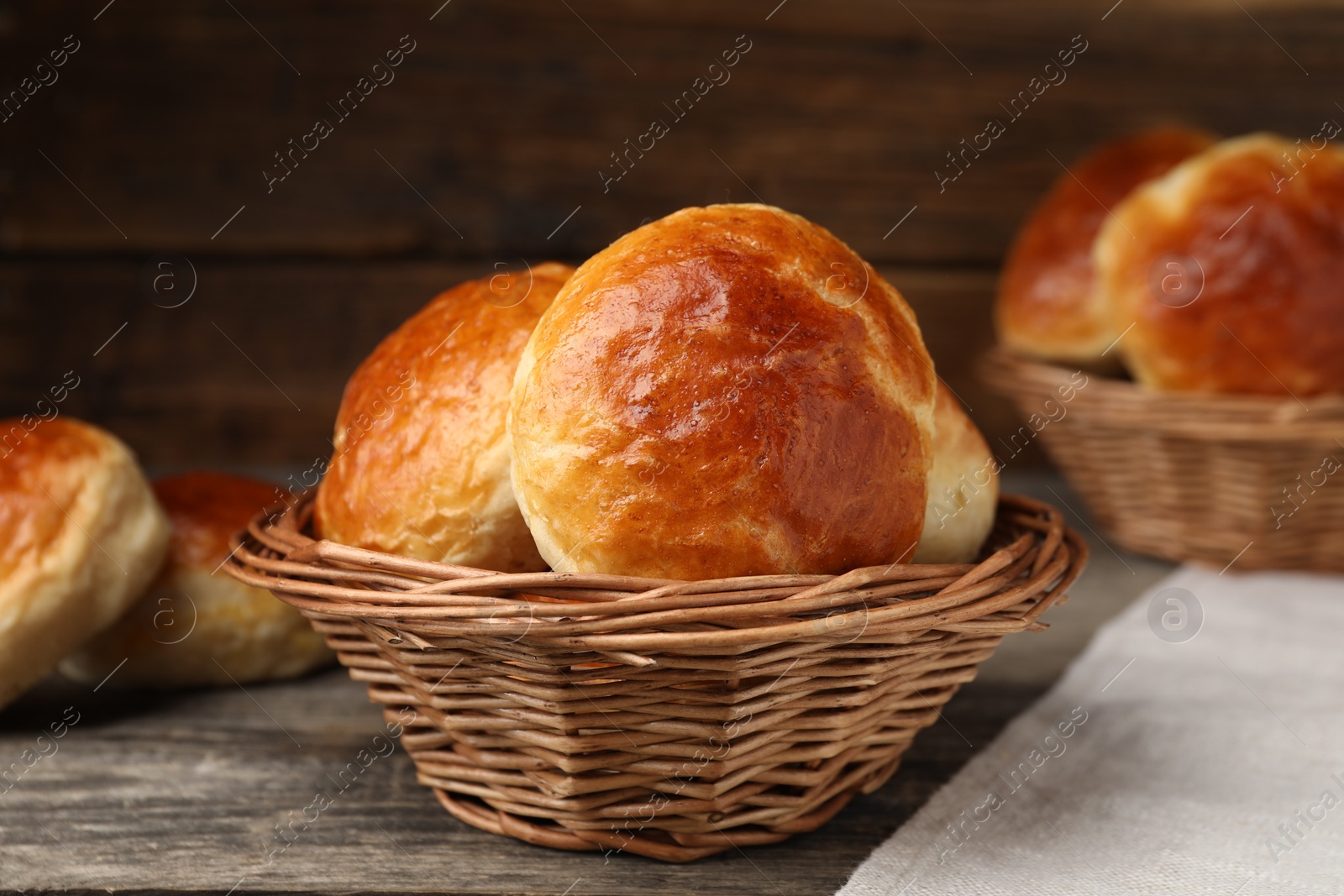 Photo of Freshly baked soda water scones on wooden table, closeup