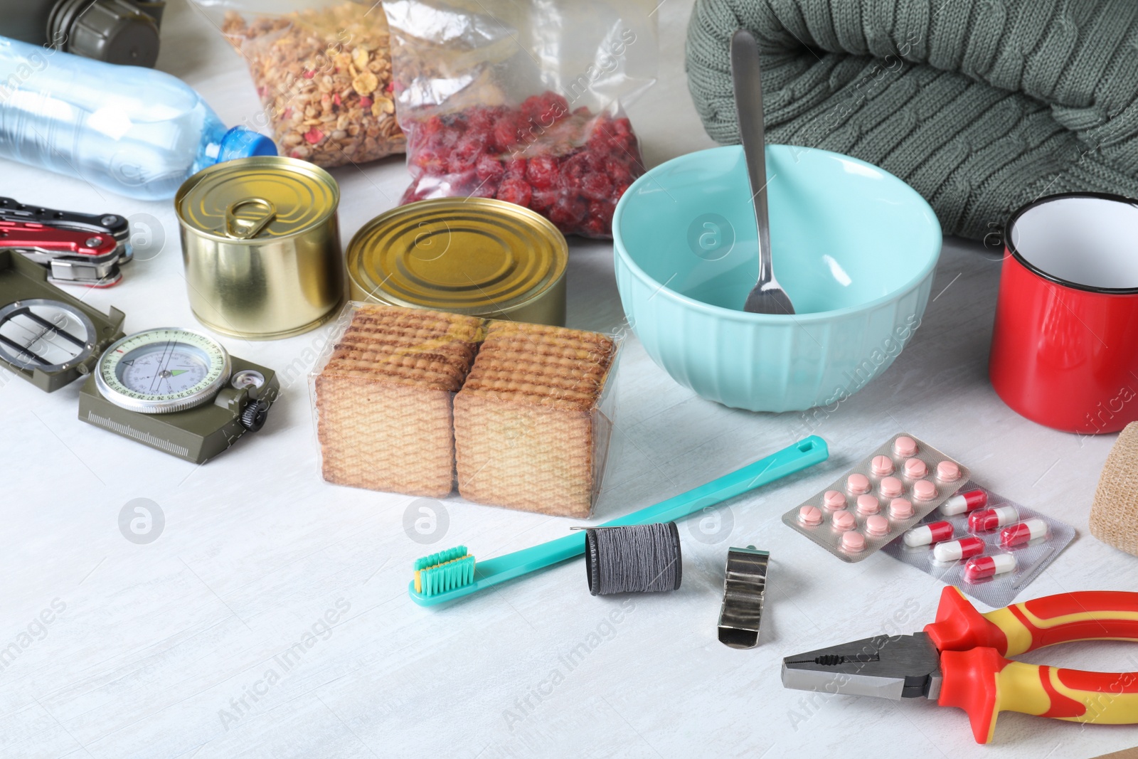 Photo of Disaster supply kit for earthquake on white wooden table