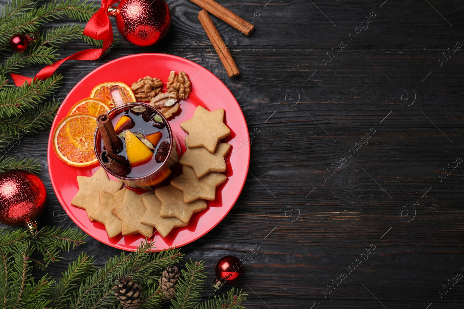 Photo of Flat lay composition with aromatic mulled wine on wooden table. Space for text