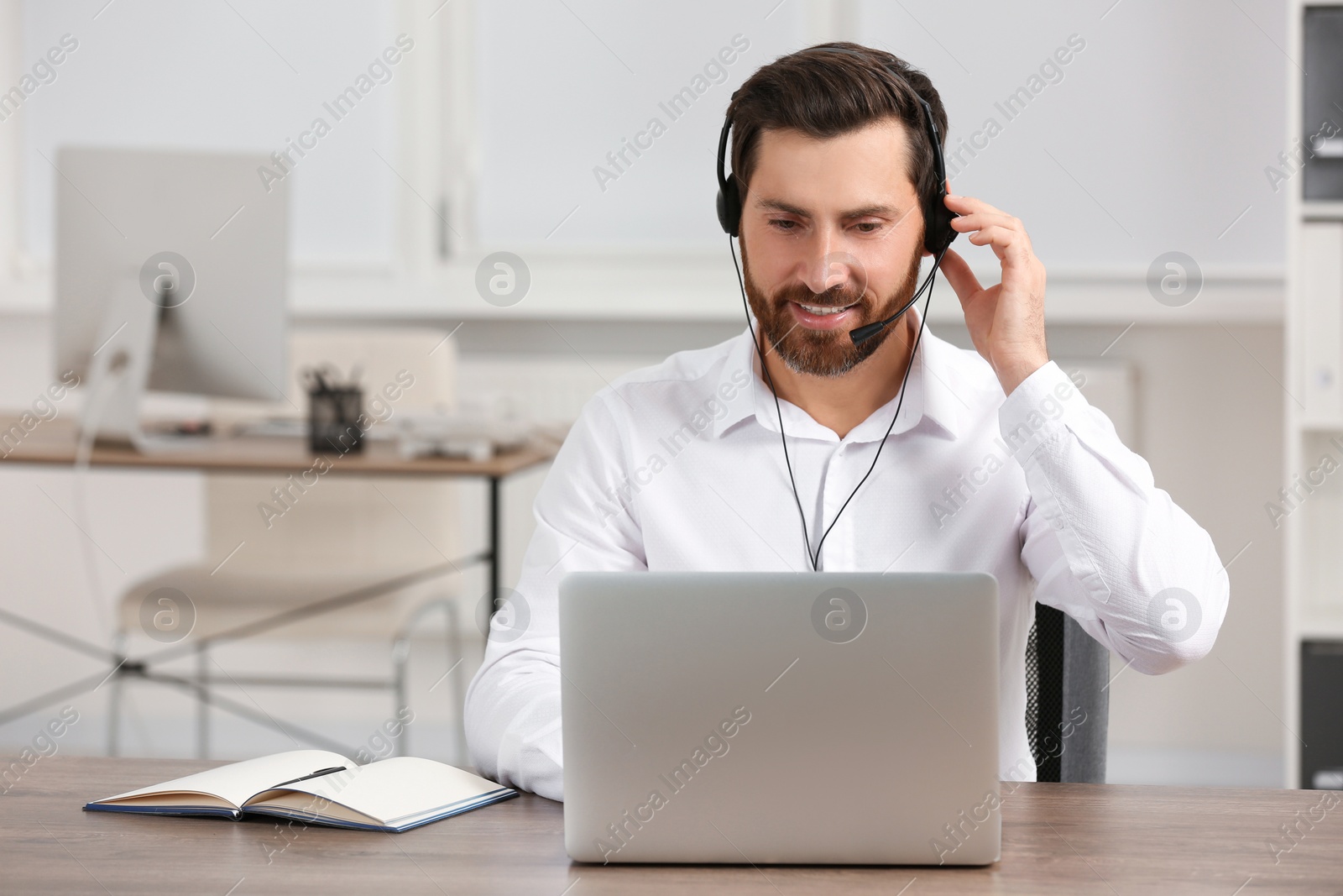 Photo of Hotline operator with headset working in office, space for text