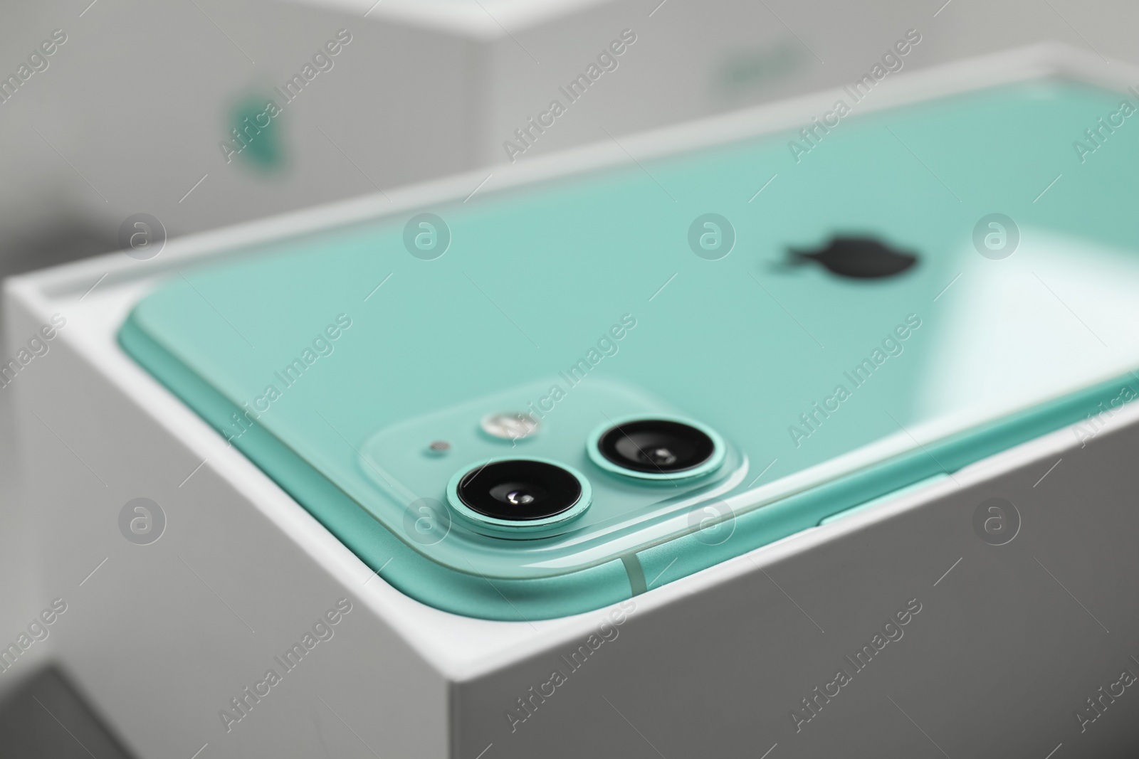 Photo of MYKOLAIV, UKRAINE - JULY 10, 2020: New modern Iphone 11 Green in original box, closeup