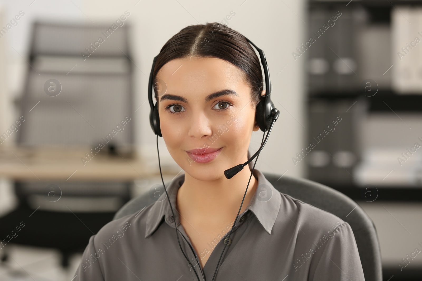 Photo of Hotline operator with headset working in office