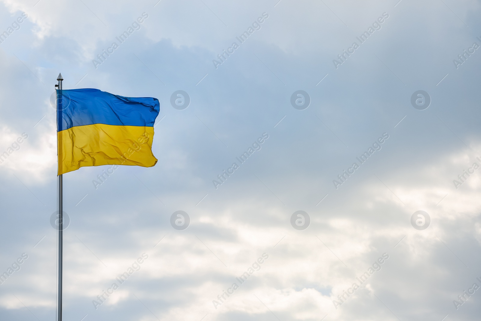 Photo of National flag of Ukraine against cloudy sky