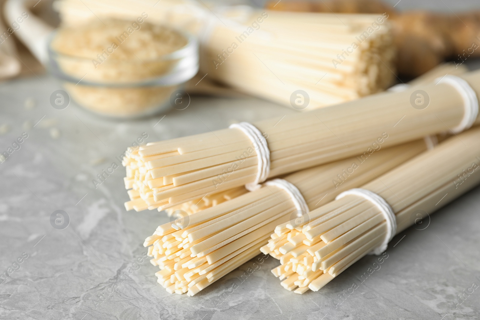 Photo of Raw rice noodles on light grey marble table