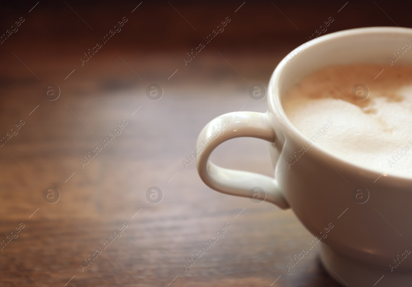 Photo of Cup of fresh aromatic coffee on table, closeup