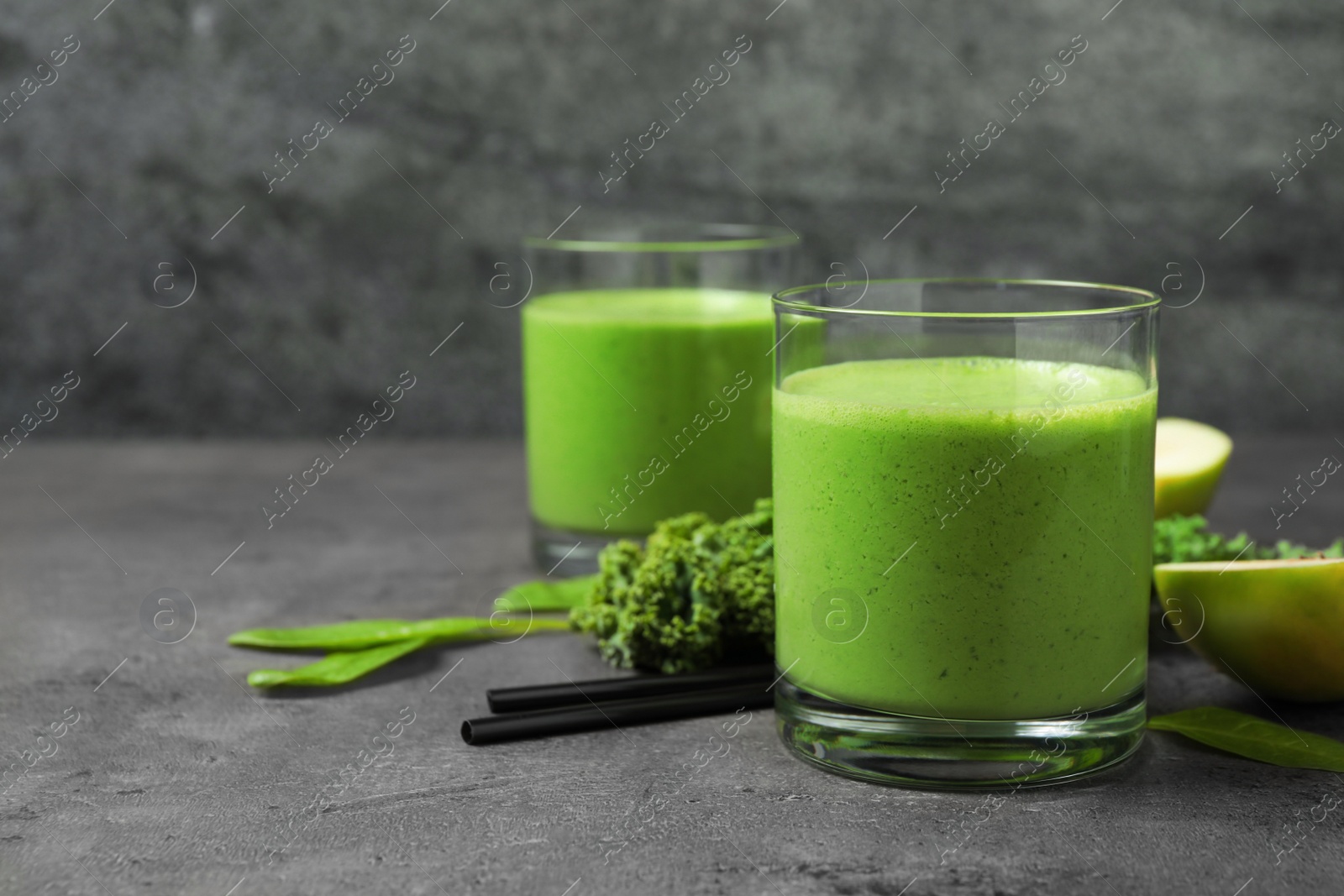 Photo of Tasty fresh kale smoothie on grey table