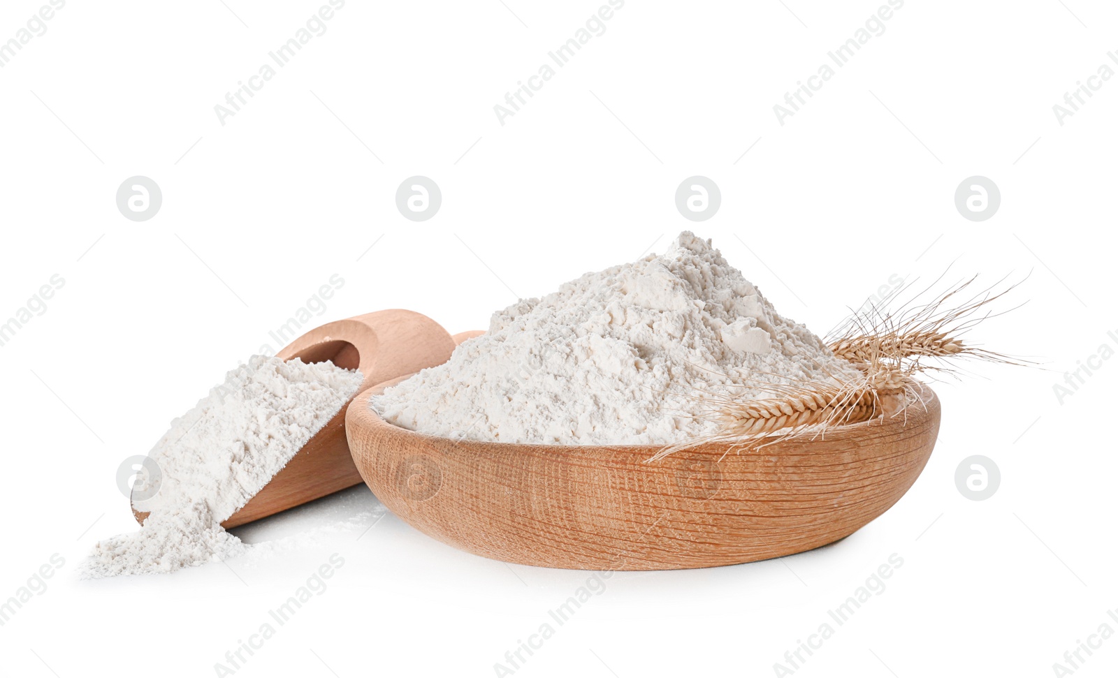 Photo of Bowl and scoop with flour on white background