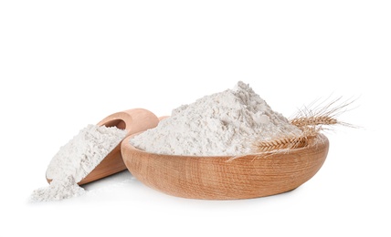 Photo of Bowl and scoop with flour on white background