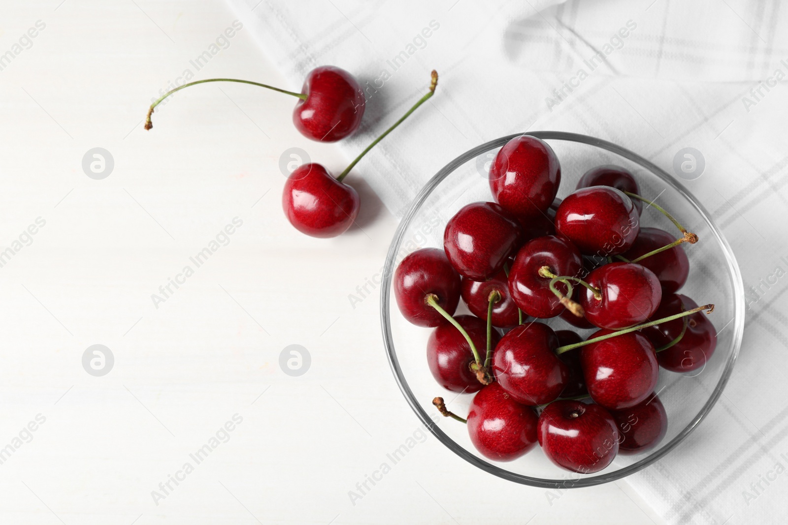 Photo of Sweet red cherries on white wooden table, flat lay. Space for text