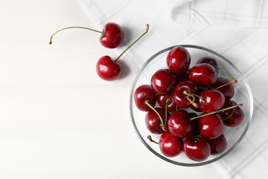 Photo of Sweet red cherries on white wooden table, flat lay. Space for text