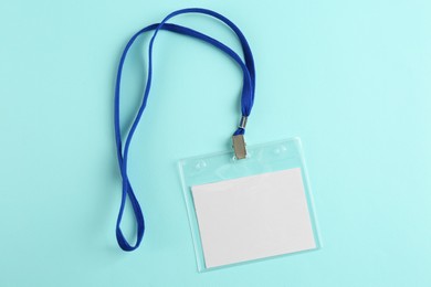 Photo of Blank badge on turquoise background, top view. Mockup for design