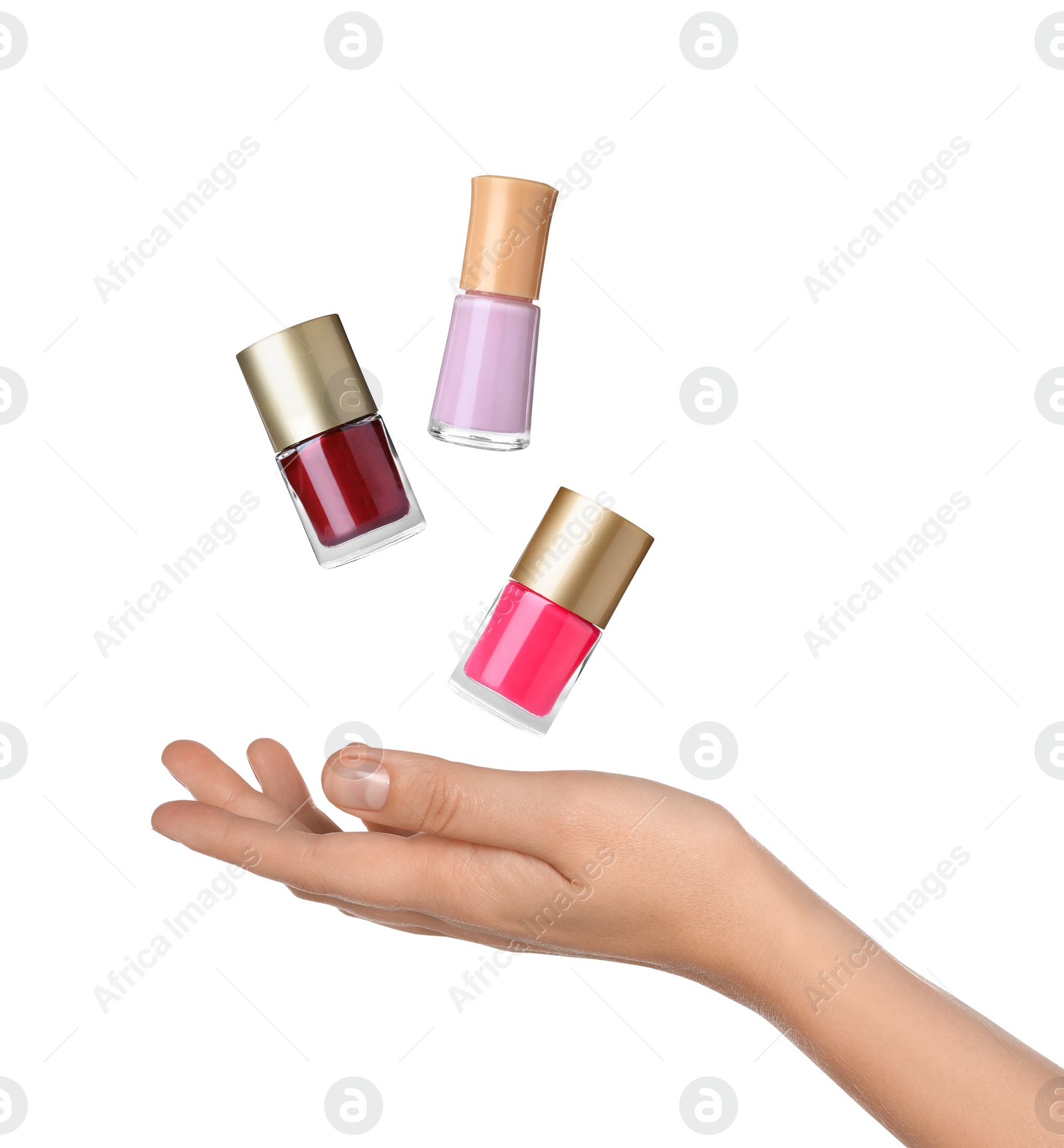 Image of Woman making bottles of nail polish levitate on white background, closeup