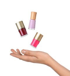 Image of Woman making bottles of nail polish levitate on white background, closeup