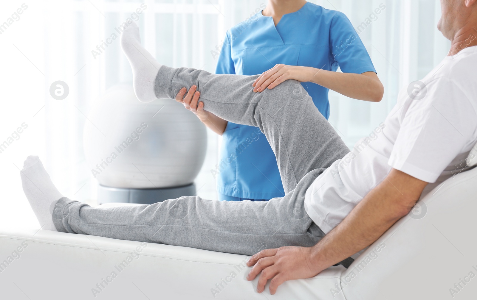 Photo of Doctor working with patient in hospital, closeup. Rehabilitation physiotherapy