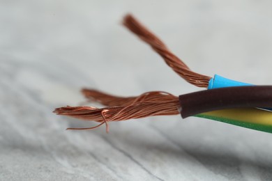 Colorful electrical wires on gray background, closeup