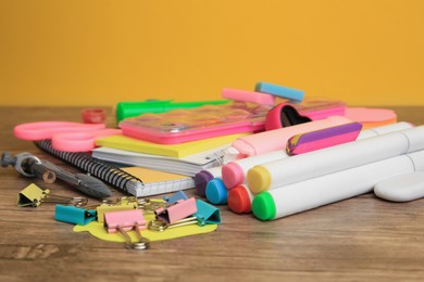 Photo of Many different school stationery on wooden table, closeup. Back to school