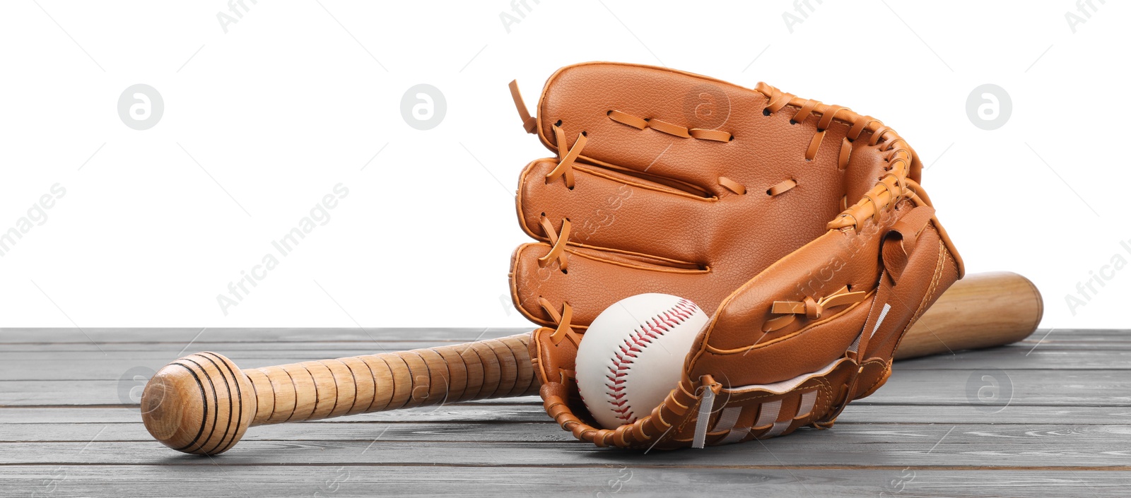 Photo of Baseball bat, ball and catcher's mitt on grey wooden table against white background
