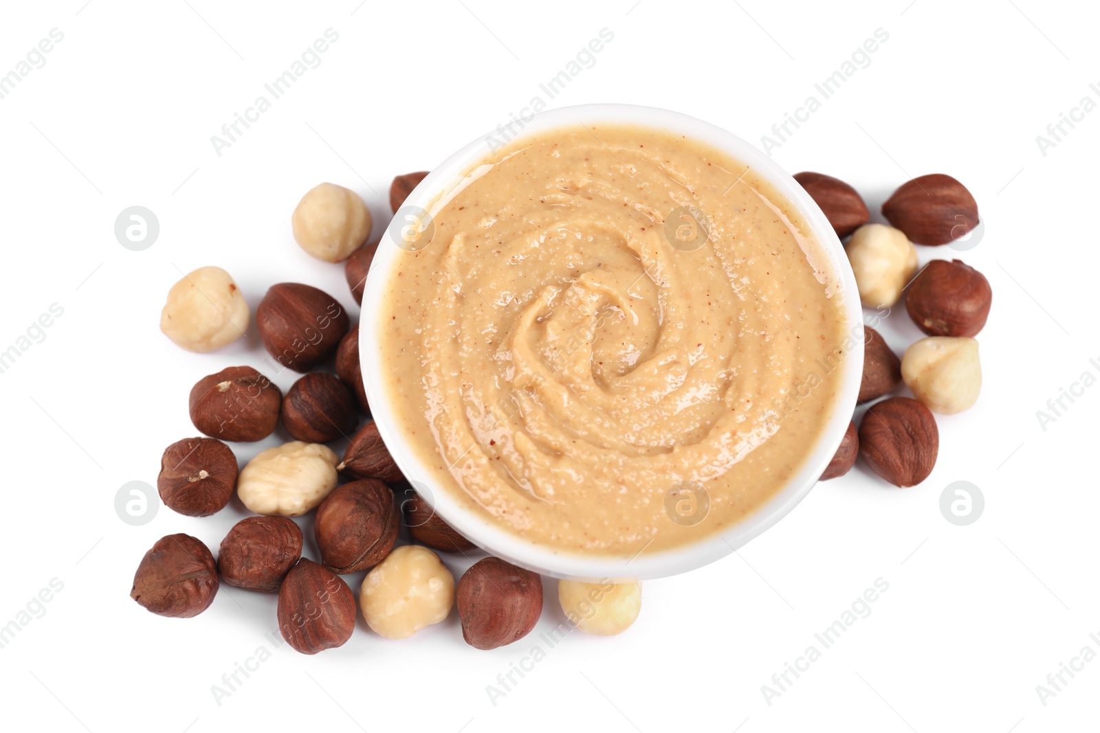 Photo of Delicious nut butter and hazelnuts isolated on white, top view