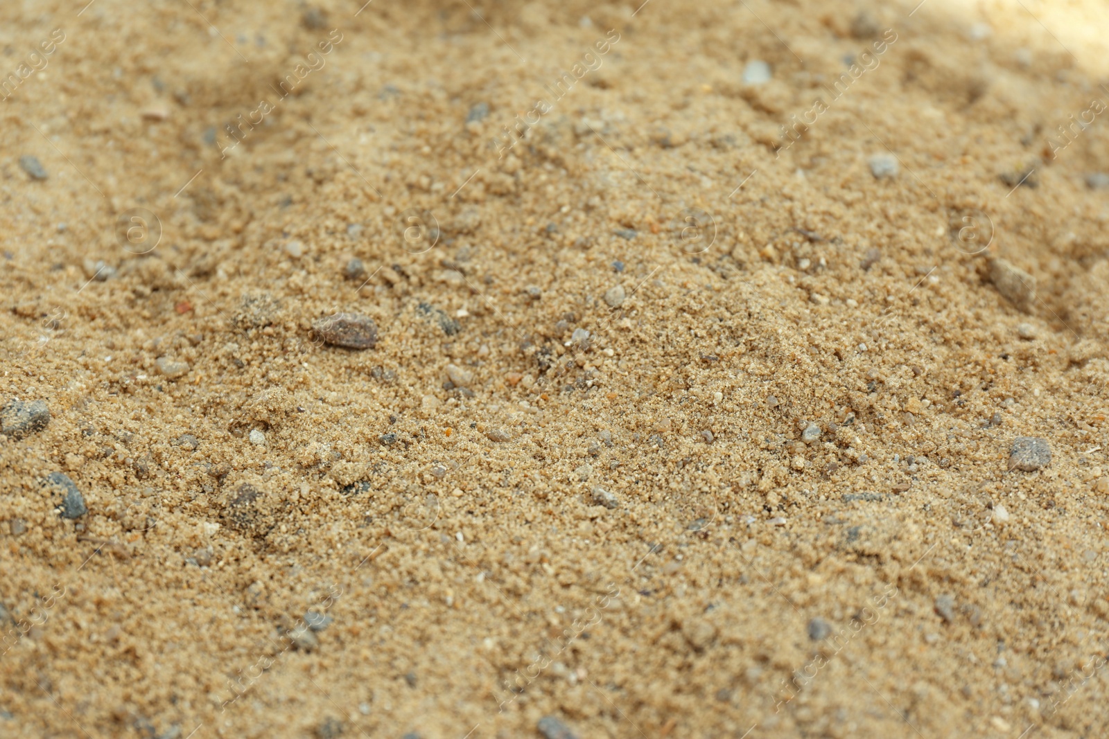 Photo of Textured sandy soil surface as background, closeup