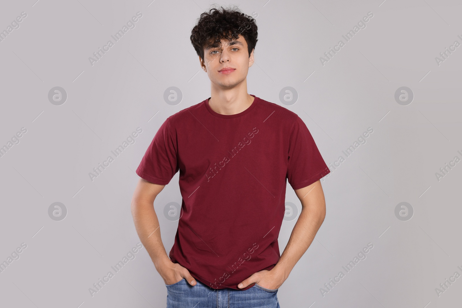 Photo of Portrait of handsome young man on light grey background