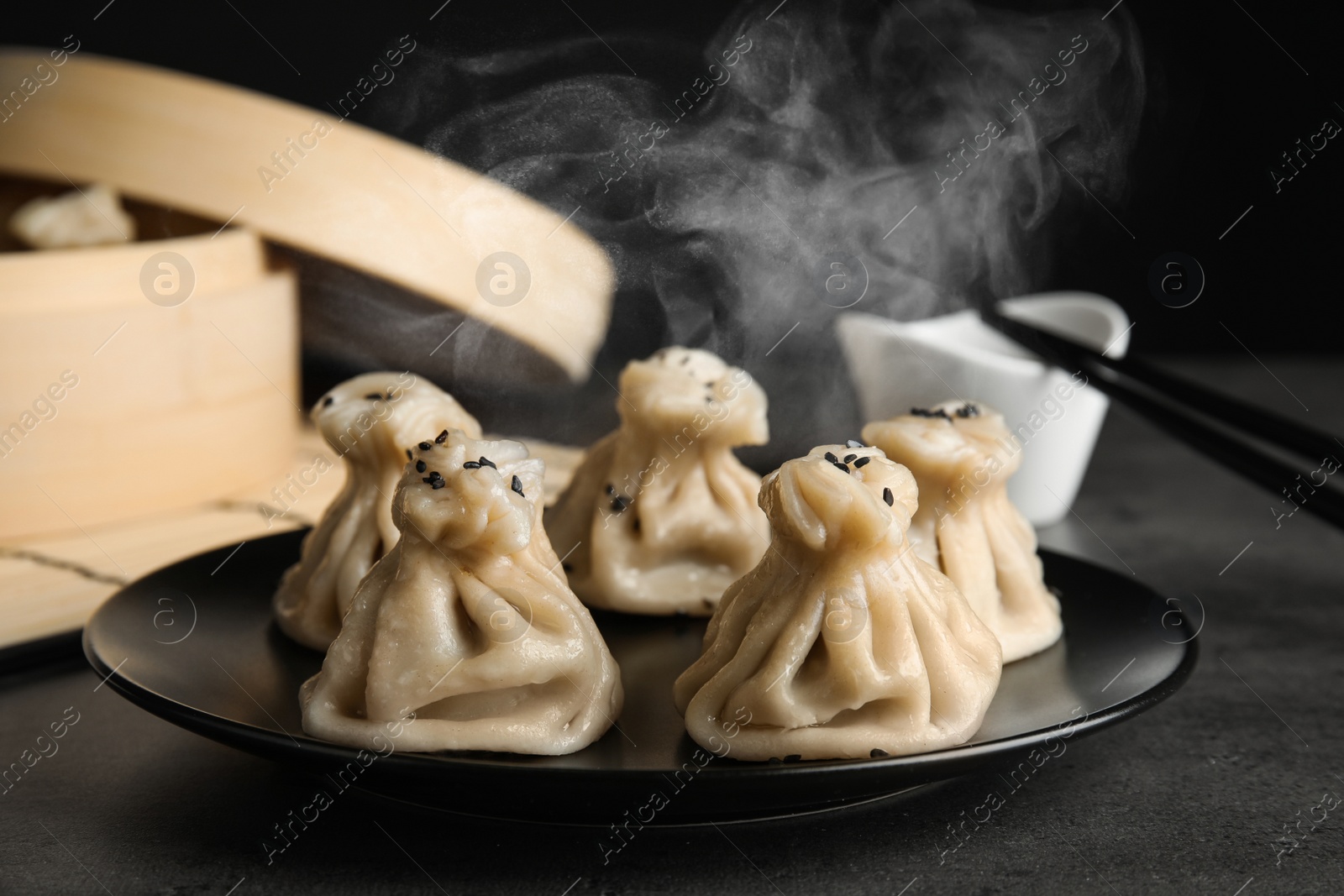 Image of Plate with tasty baozi dumplings on table