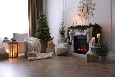 Photo of Stylish room interior with fireplace and beautiful Christmas tree