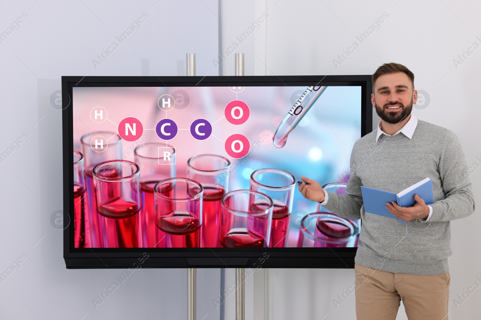 Photo of Teacher using interactive board in classroom during lesson