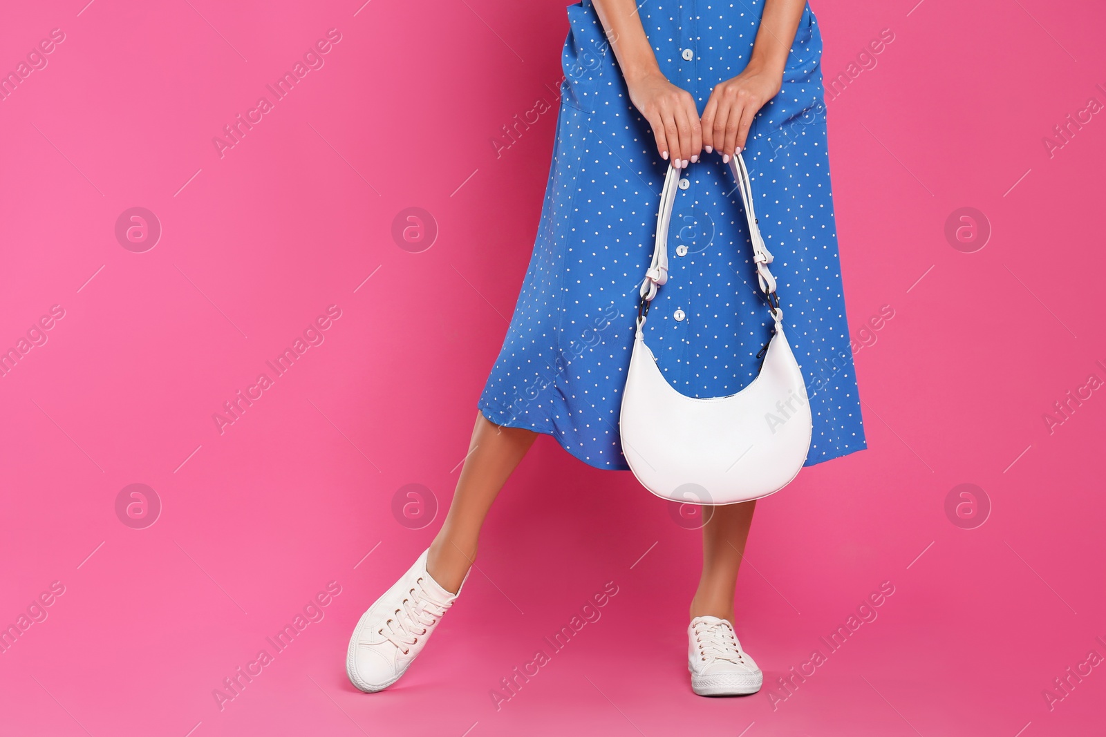 Photo of Woman with stylish bag on pink background, closeup. Space for text