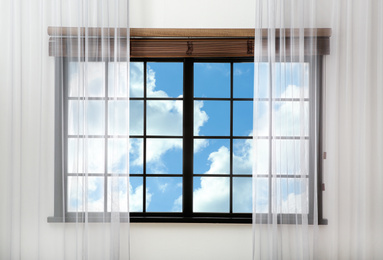 Image of Beautiful view on blue sky with clouds through window