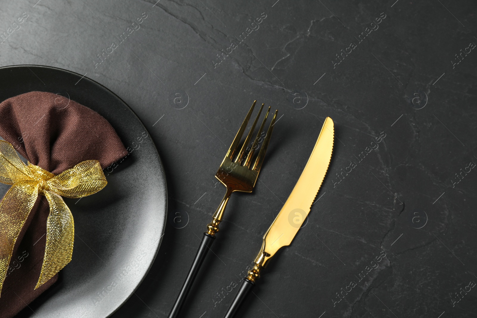 Photo of Stylish setting with elegant cutlery on grey textured table, flat lay