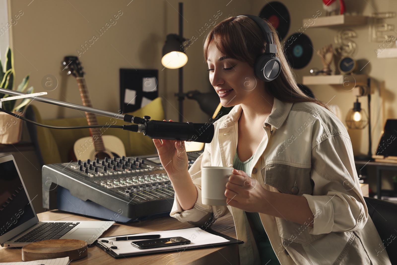 Photo of Woman working as radio host in modern studio