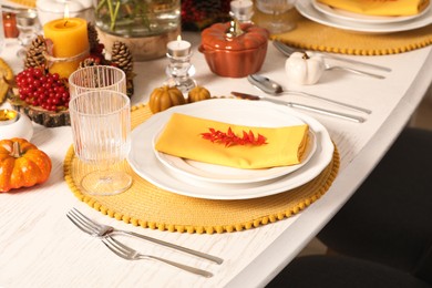 Photo of Autumn table setting with floral decor and pumpkins indoors