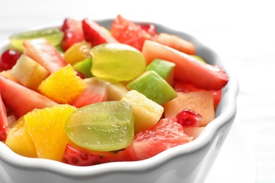 Photo of Bowl with fresh cut fruits, closeup