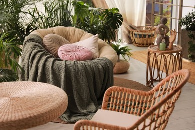 Photo of Indoor terrace interior with soft papasan chair and green plants