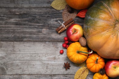 Photo of Happy Thanksgiving day. Flat lay composition with pumpkins and apples on wooden table, space for text