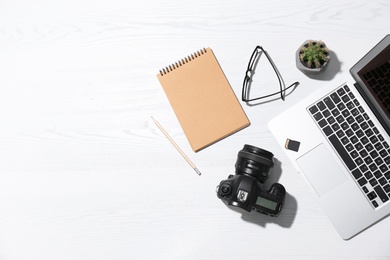 Photo of Flat lay composition with equipment for professional photographer on wooden background. Space for text