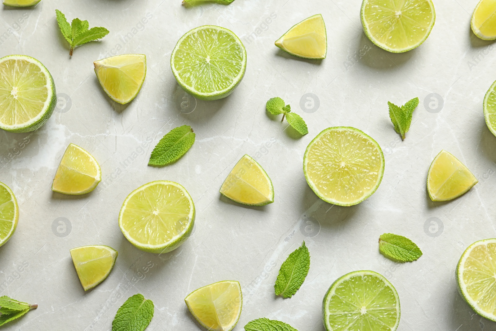 Photo of Composition with fresh ripe limes on light background, top view