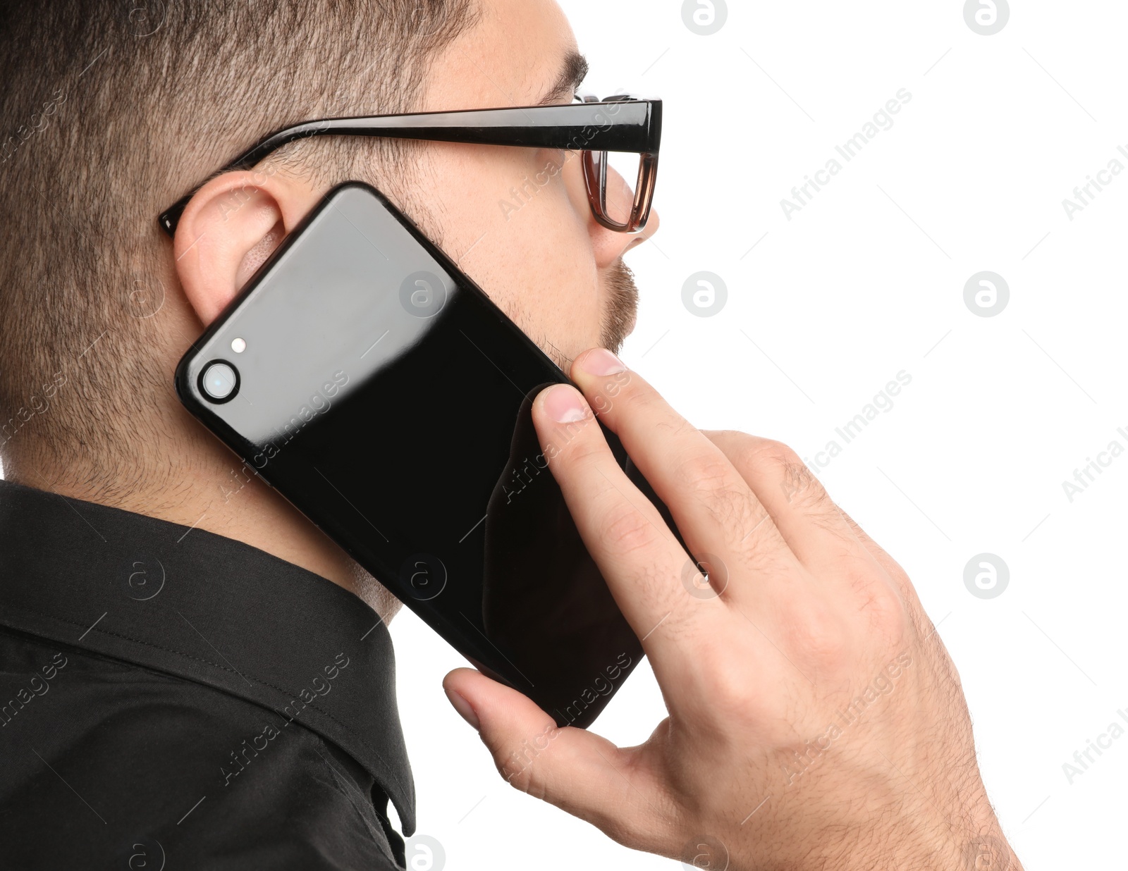 Photo of Young businessman talking on smartphone against white background, closeup