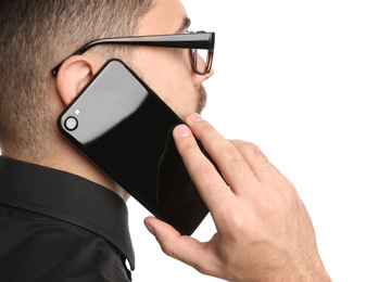 Photo of Young businessman talking on smartphone against white background, closeup