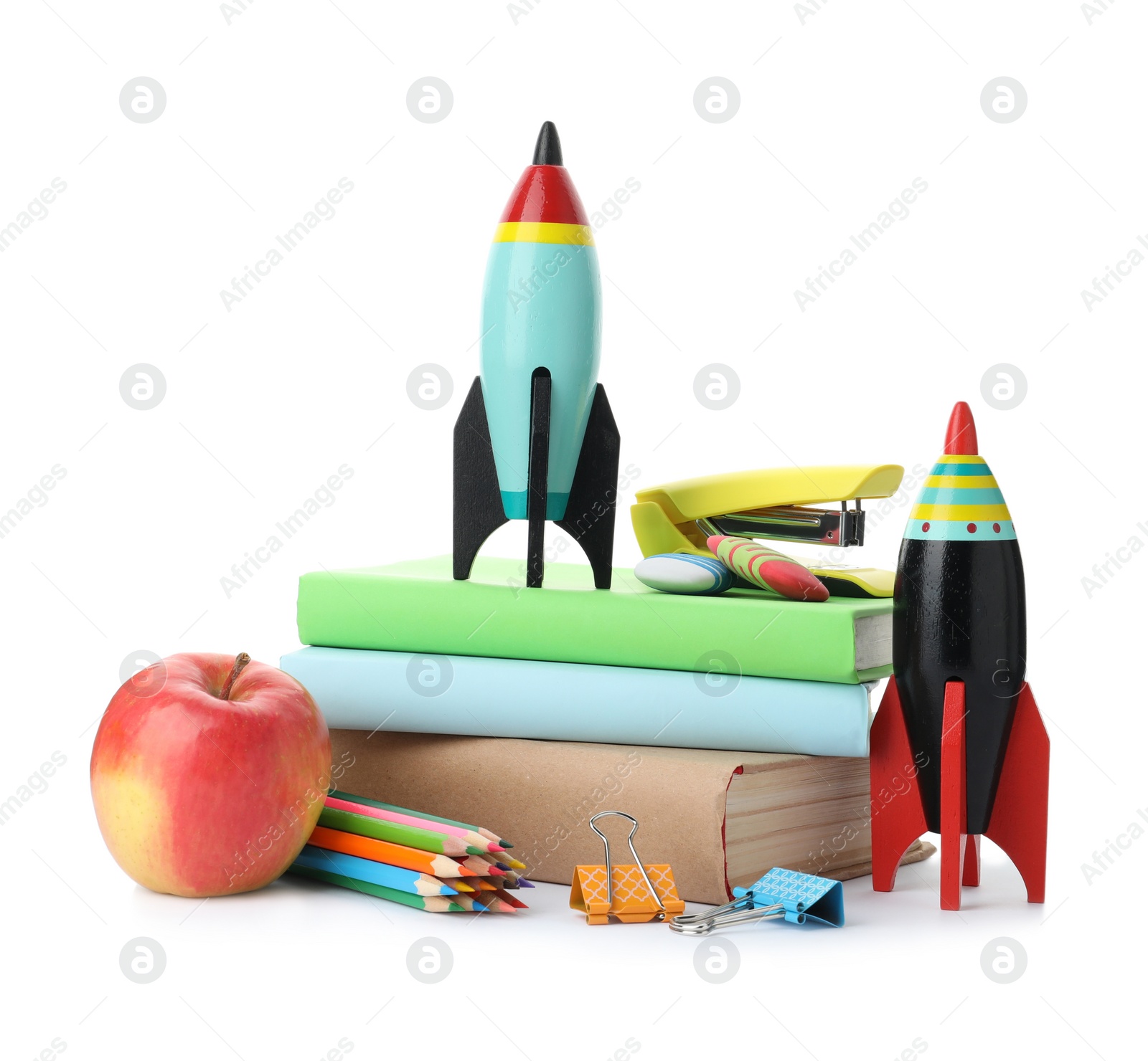 Photo of Bright toy rockets and school supplies on white background