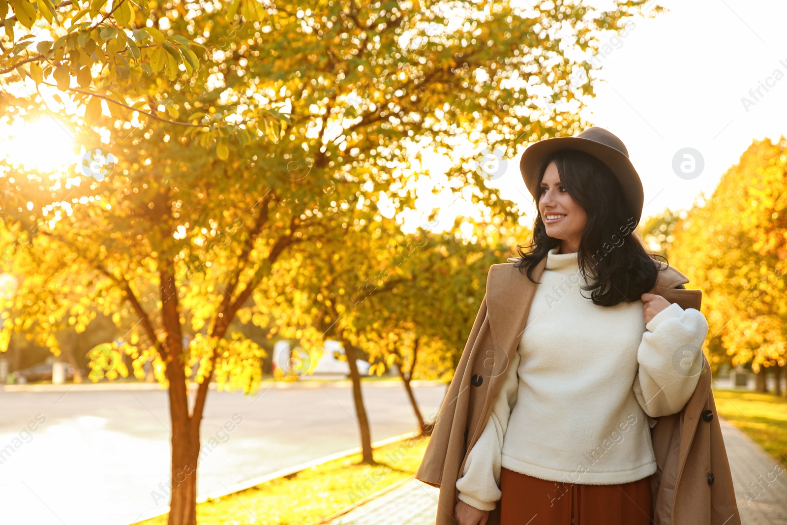 Photo of Beautiful young woman wearing stylish clothes in autumn park