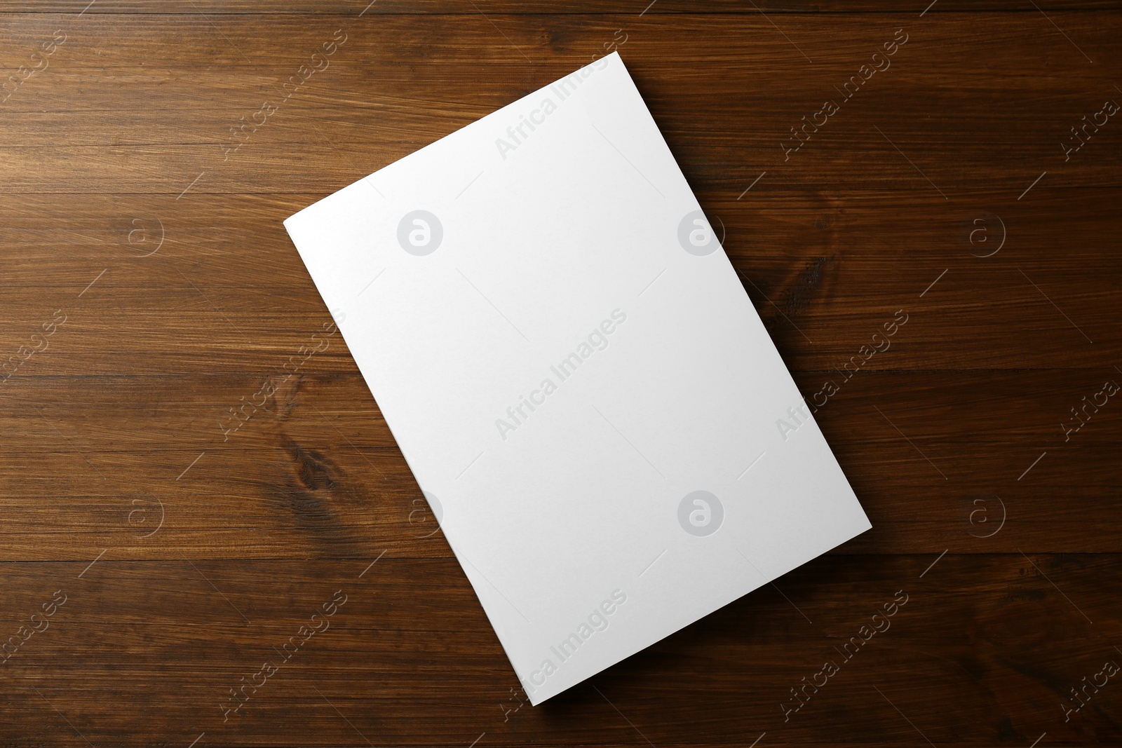 Photo of Blank paper brochure on wooden table, top view. Mockup for design