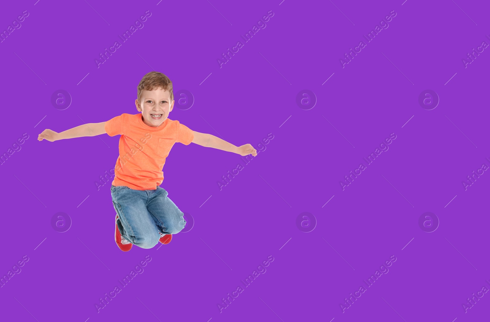 Image of Happy boy jumping on purple background, space for text