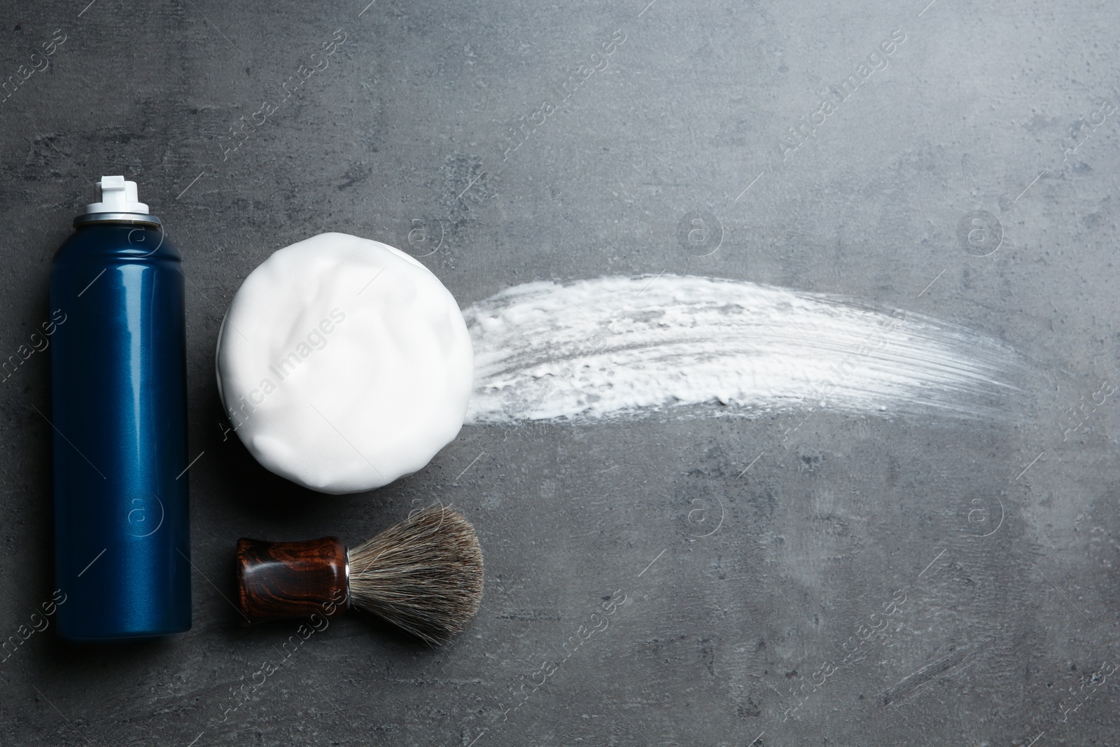 Photo of Flat lay composition with shaving accessories and foam stroke on gray background