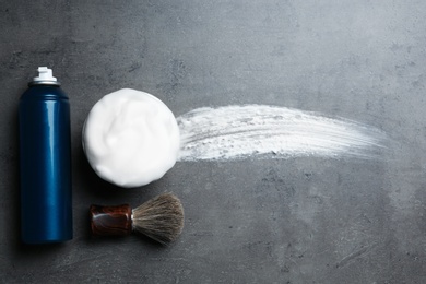 Photo of Flat lay composition with shaving accessories and foam stroke on gray background