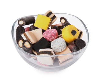 Photo of Glass bowl with many tasty liquorice candies isolated on white