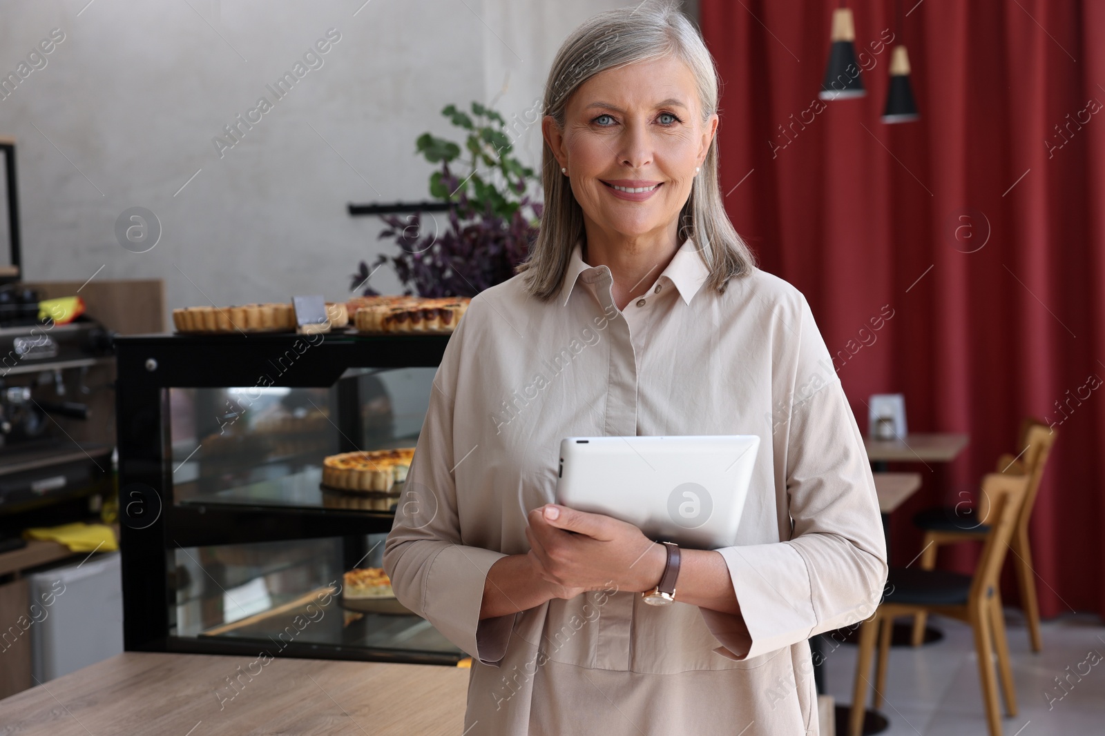 Photo of Happy business owner with tablet in her cafe, space for text