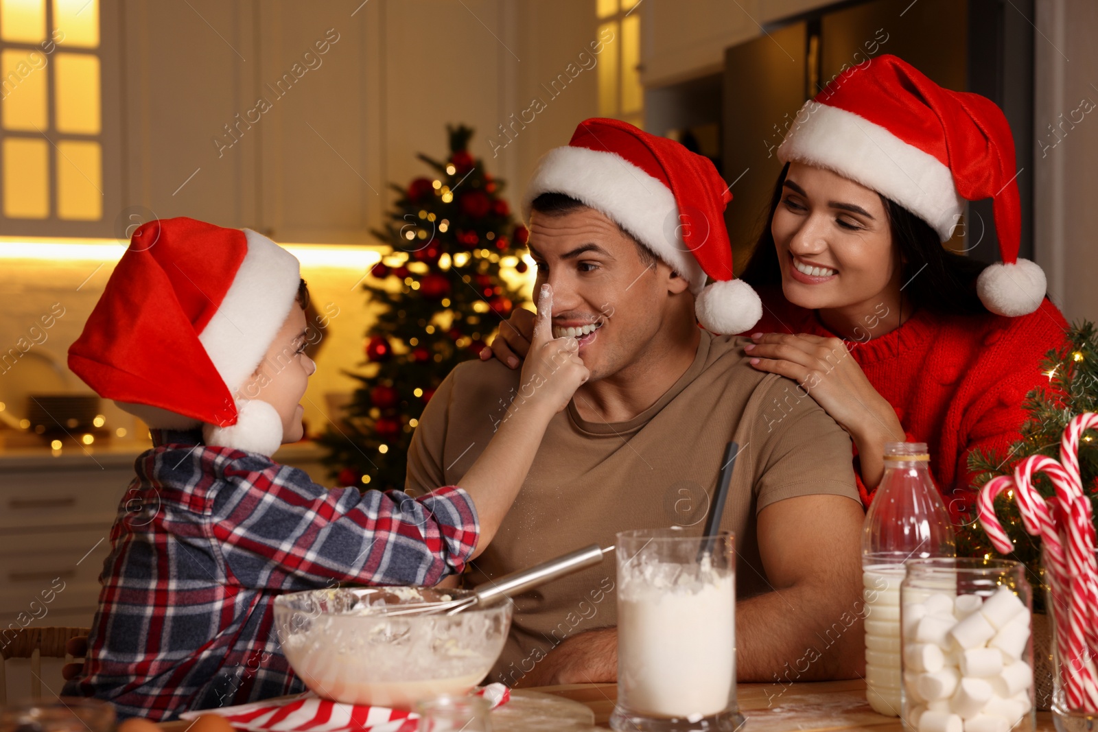 Photo of Happy family making dough for Christmas cookies at home